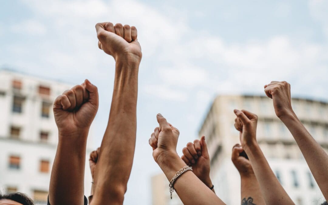 People with raised fists at a demonstration